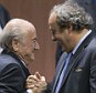 FILE - In this Friday, May 29, 2015 file photo, FIFA president Sepp Blatter after his election as President, left, is greeted by UEFA President Michel Platini, right, at the Hallenstadion in Zurich, Switzerland. FIFA's ethics committee has asked for sanctions against Sepp Blatter and Michel Platini after finishing investigations into their alleged financial wrongdoing. FIFA President Blatter and UEFA President Platini now face bans of several years at full hearings before FIFA ethics judge Joachim Eckert, likely in December.   (Patrick B. Kraemer/Keystone via AP, File)