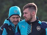 Arsenal midfielder Ramsey in discussion with the club's fitness coach Tony Colbert (left)