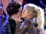 LOS ANGELES, CA - NOVEMBER 22:  Singers Charlie Puth (L) and Meghan Trainor kiss onstage during the 2015 American Music Awards at Microsoft Theater on November 22, 2015 in Los Angeles, California.  (Photo by Kevin Winter/Getty Images)