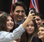 Canadian Prime Minister Justin Trudeau has his photo taken with students from a local school following an information session on climate change during a First Ministers meeting at the Museum of Nature on Monday, Nov. 23, 2015 in Ottawa. (Adrian Wyld/The Canadian Press via AP) MANDATORY CREDIT