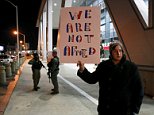 Caleb Gay of Newnan, stands with a sign saying "We are not afraid" alongside Atlanta police officers standing guard outside the WWE Survivor Series, a professional wrestling event at Philips Arena in Atlanta, Georgia November 22, 2015. The Federal Bureau of Investigation said on Saturday (November 21) it did not view a reported threat by Islamic State militants to attack a professional wrestling event in Atlanta this weekend as credible.  REUTERS/Tami Chappell