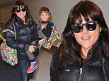 Selma Blair and son Arthur are all bundled up at LAX before taking a trip out of town for Thanksgiving weekend. Selma and Arthur also carried very colorful matching bags. November 25, 2015 X17online.com