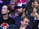 Actors, from left, Olivia Wilde, Will Forte and Jason Sudeikis watch during the second half of an NBA basketball game between the Los Angeles Clippers and the Orlando Magic, Saturday, Dec. 5, 2015, in Los Angeles. The Clippers won 103-101. (AP Photo/Mark J. Terrill)