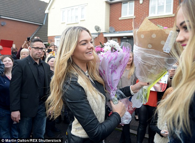 Touched: The 17-year-old couldn't contain her delights as kind-hearted supporters gave her bouquets of flowers
