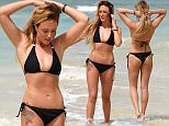 *** NOTE TO PIC DESK *** MIN USAGE FEE OF £250 FOR ONLINE GALLERY ***
PIC FROM MERCURY PRESS
(PICTURED - Charlotte shows off her fantastic beach body in Cape Verde)
Rump too plump? Not Charlotte Crosby. The 25-year-old Geordie Shore babe flaunted her best ÎassÌet in a skimpy black bikini after announcing the launch of new fitness DVD Three Minute Bum Blitz. The workout has certainly paid off for the reality TVÌs own juicy behind, which looked perfectly pert as she relaxed on the beach in Cape Verde. But Charlotte Ò who is currently dating Love Island hunk Max Morley Ò proved her posterior isnÌt the only thing turning heads since shedding more than 2st 7lbs this year.  The stunner also put her perfectly toned and tanned legs and enviably flat stomach on display as she frolicked on the sand while staying at The Resort GroupÌs Melia Dunas Hotel in Sal.SEE MERCURY COPY