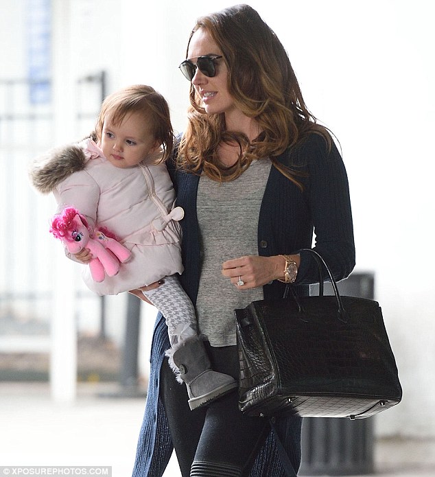 JEt-setting pair: Making her way through JFK airport with her adorable 21-month-old daughter, Sophia, the Formula One heiress, 31, looked at ease with the rigours of flying in a stylish yet comfortable ensemble