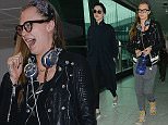 EXCLUSIVE ***MINIMUM FEE £500 PER PAPER APPLIES*** Cara Delevingne shows off her geeky side, as she walks through Heathrow Airport with girlfriend  Annie Clark aka St Vincent, wearing some thick black rimmed glasses. She was also wearing a "Cake" necklace, in reference to her close friendship with Kendall Jenner\n11 December 2015.\nPlease byline: Will/PalaceLee/Vantagenews.com