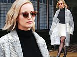 12/13/2015\nJennifer Lawrence exits the Greenwich Hotel on the way to a press junket for "Joy" in New York City. Ms Lawrence stepped out looking fab in long white and gray knit coat, and black turtleneck and white fringe skirt. \nsales@theimagedirect.com Please byline:TheImageDirect.com