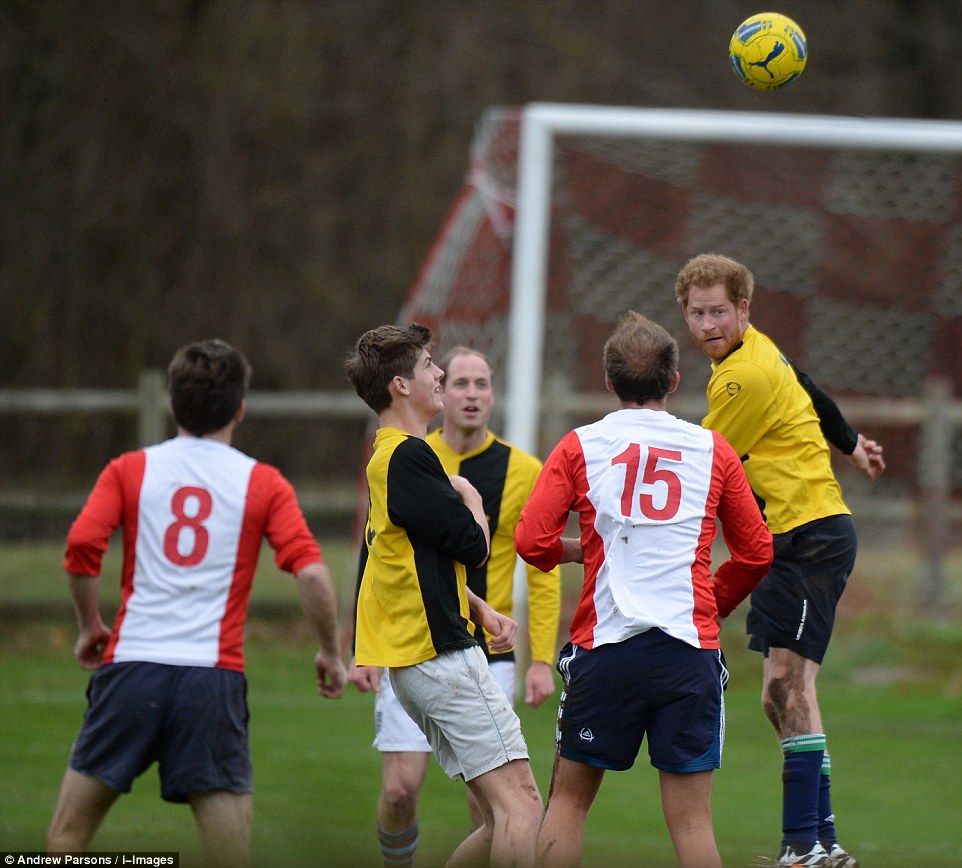Villagers living near the Queen's Sandringham estate had the chance to glimpse the football skills of Prince Harry and Prince William during a Christmas Eve match - pictured, Harry heading the ball as William looks on in the background