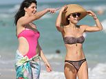 146304, Bethenny Frankel shows off her figure in a L'Space bandeau bikini as she stops to chat with Brittny Gastineau on the beach in Miami. Bethenny was seen taking a walk this afternoon in a Mayan Quest Kaella bikini from L'Space, retailing at $150. Bethenny and Brittny stopped to chat and share a laugh. 33 year old Brittny who is also a former reality tv star, wore a baby pink cutout one piece. Miami, Florida - Monday December 28, 2015. Photograph: Brett Kaffee/Thibault Monnier, ¬© Pacific Coast News. Los Angeles Office: +1 310.822.0419 sales@pacificcoastnews.com FEE MUST BE AGREED PRIOR TO USAGE