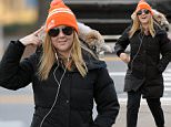 EXCLUSIVE TO INF.\nJanuary 7, 2016: Amy Schumer staying warm in a 'Wear Orange' beanie which calls attention to gun violence and safety, and a black puffer coat listens to music as she is photographed this morning smling and jogging in New York City. Schumer has lots to smile about as she posted photos of her and new boyfriend Chicago furniture designer Ben Hanisch last week.\nMandatory Credit: Elder Ordonez/INFphoto.com Ref: infusny-160