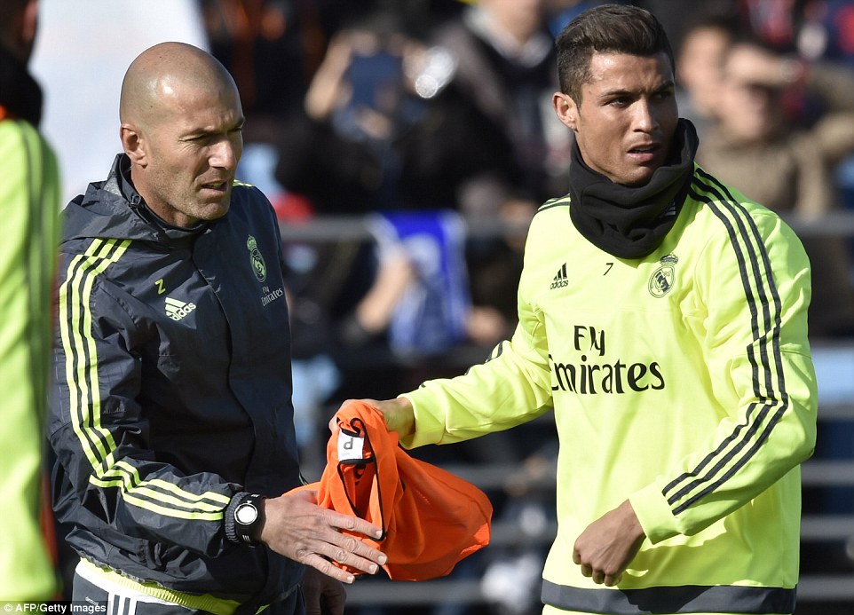 Ronaldo hands his new manager his bib during training at the Valdebebas complex in Madrid on Tuesday