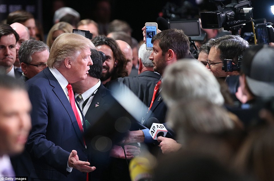 Trump speaks to several members of the media in the spin room following Thursday's fiery Republican debate