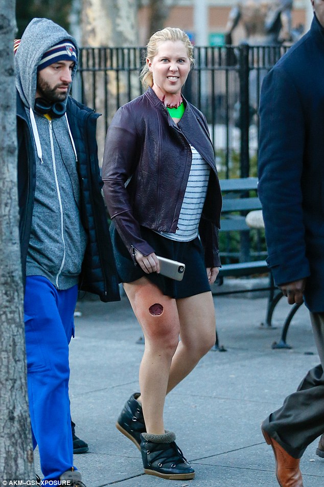 Inside! Amy Schumer brandished open wounds and 'had her head ripped off' as she filmed a scene in New York for an upcoming episode of her show