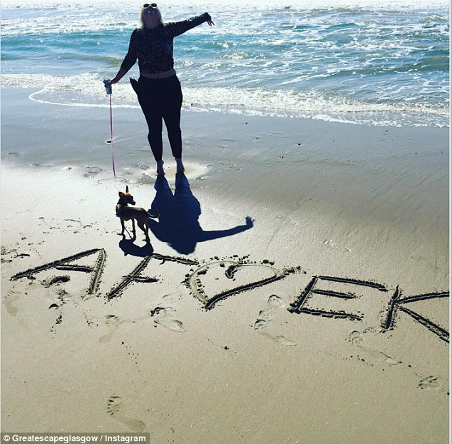 Smitten: They both shared loved-up images of their trip, including inscribing their initials in the sand on the beach.