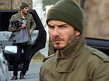 David Beckham pictured with his hands full after the school run as he took his daughter's scooter indoors for her.\nNoble Draper Pictures.\n**BYLINE: NOBLE/DRAPER**