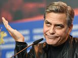 Actor George Clooney  jokes during a press conference for the film 'Hail Caesar' at the 2016 Berlinale Film Festival in Berlin, Germany, Thursday, Feb. 11, 2016. (Jens Kalaene/dpa via AP)