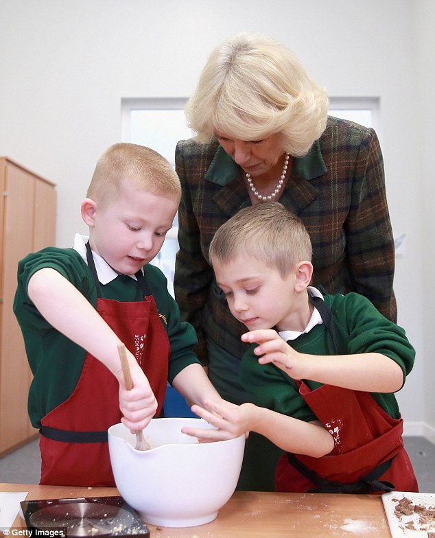 Although she didn't appear to get her hands dirty, the wife of Prince Charles was keen to see how they young cooks were getting on with making their cookie dough as she peered into the mixing bowl