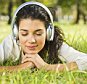 A stock photo of young woman listening to music.