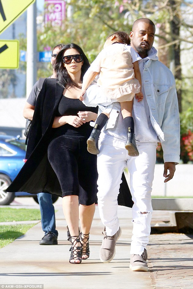 Family first: Kim, pictured with her daughter North West and husband Kanye in West Hollywood in February, has recently made a big statement about where she stands when it comes to her husband's wild tweets