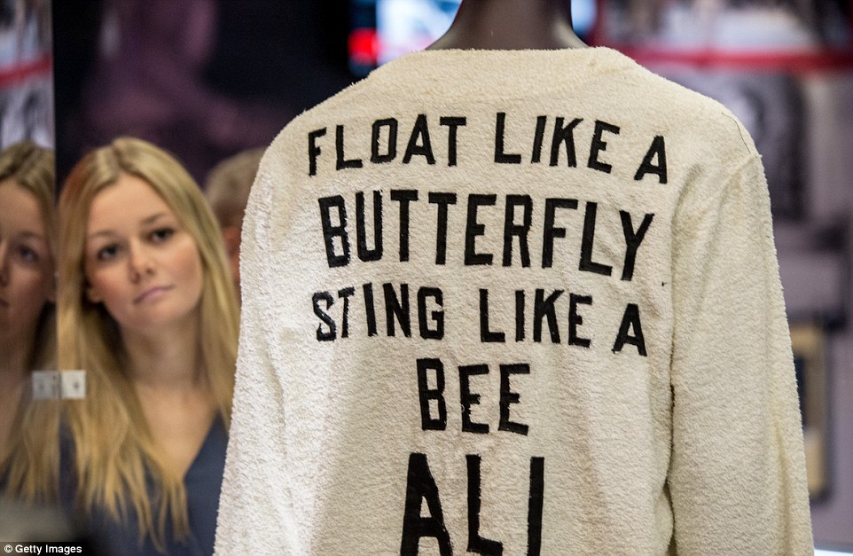 The words 'Float like a butterfly sting like a bee' and 'Ali' are displayed on the back of the robe which was worn by corner man Brown