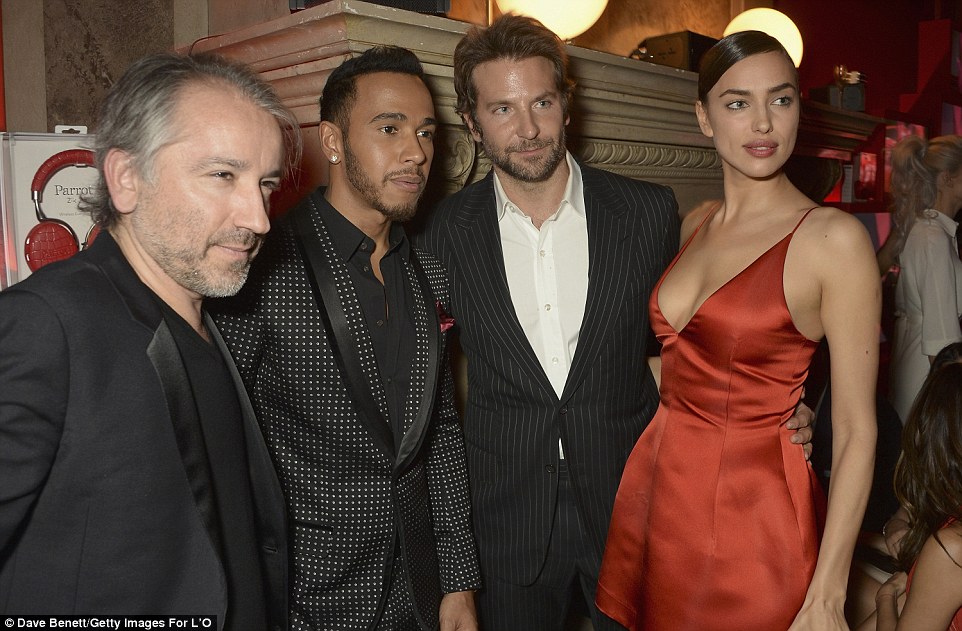 Friends in high places: Irina had her handsome boyfriend Bradley Cooper (second from right) in tow on the night, with the pair catching up with Formula 1 champ Lewis Hamilton (second from left) and Cyril Chapuy, (left) the President of L'Oreal Paris