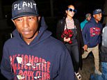 Los Angeles, CA - Singer, Pharrell Williams, arrives at LAX holding hands with his wife, Helen Lasichanh.  He was seen wearing a pullover hoodie with 'Billionaire Boys Club' on it, khaki pants, and gray suede boots.  How wife, Helen Laichanh, was seen in a black sweater, striped shirt, black overalls, black socks, Birkenstock sandals, and blue frame sunglasses.\nAKM-GSI          March 1, 2016\nTo License These Photos, Please Contact :\nSteve Ginsburg\n(310) 505-8447\n(323) 423-9397\nsteve@akmgsi.com\nsales@akmgsi.com\nor\nMaria Buda\n(917) 242-1505\nmbuda@akmgsi.com\nginsburgspalyinc@gmail.com