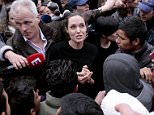 ATHENS, GREECE - MARCH 16: Special envoy of the United Nations High Commissioner for Refugees, Angelina Jolie talks to young migrants during her  visit to the temporary refugee facilities at the port of Piraeus on March 16, 2016 in Athens, Greece. (Photo by Milos Bicanski/Getty Images)