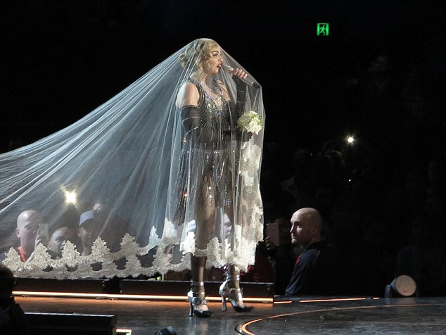 Bridal inspired: She also donned a wedding veil and carried a bouquet during one of performances 