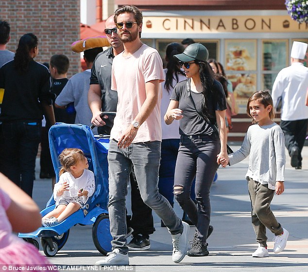 The Lord is with them: Scott, 32, looked relaxed as he played the doting dad, and looked casually cool in grey jeans and white sneakers with a pink t-shirt and shades