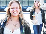 Picture Shows: Ronda Rousey  March 24, 2016\n \n MMA fighter Ronda Rousey was spotted grabbing some coffee from Starbucks in Los Angeles, California.\n \n Before getting something to drink, two police officers stopped to ask her for a photo. Ronda was dressed casually in a black leather jacket, a white button up top, blue skinny jeans and black boots.\n \n Exclusive ALL ROUND\n UK RIGHTS ONLY\n \n Pictures by : FameFlynet UK © 2016\n Tel : +44 (0)20 3551 5049\n Email : info@fameflynet.uk.com