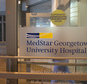 A woman walks out of the MedStar Georgetown University Hospital in Washington, Monday, March 28, 2016.  Hackers crippled computer systems at a major hospital chain, MedStar Health Inc., on Monday, forcing records systems offline for thousands of patients and doctors. The FBI said it was investigating whether the unknown hackers demanded a ransom to restore systems.  (AP Photo/Molly Riley)