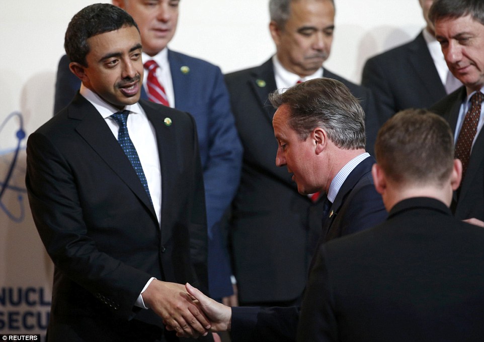 ... Meanwhile, in the shadows: Cameron was isolated from the power players and looked dejected as he shook hands with UAE foreign affairs minister Abdullah bin Zayed bin Sultan Al Nahyan