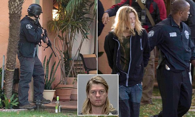 Puddle Of Mudd singer is led away from his Los Angeles home following stand-off
