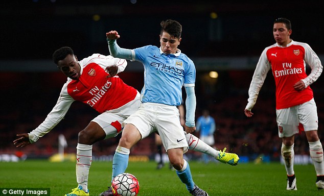 City playmaker Manuel Garcia Alonso holds off pressure from Arsenal's Marc Bola at the Emirates Stadium