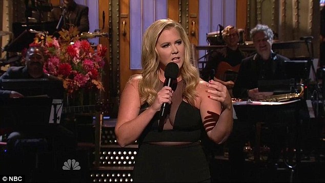 'Am I dating him?' Amy Schumer says she changed her relationship status on Facebook to engaged after an awkward encounter with Bradley Cooper during her monologue on SNL