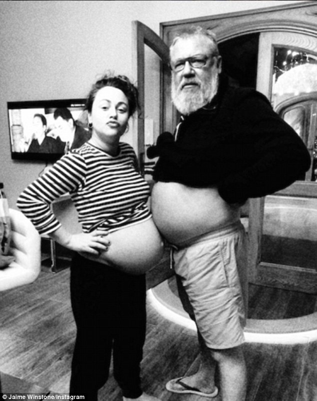 Festive fun: Over Christmas Jaime posed for a funny photo with doting daddy Ray Winstone - comparing her blossoming baby bump to his own burgeoning bare stomach