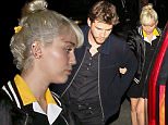 11 April 2016 - Brentwood, CA - USA\n**STRICTLY AVAILABLE FOR UK AND GERMANY USE ONLY**\n*NO WEB USAGE UNTIL FURTHER NOTICE*\n*PREMIUM EXCLUSIVE - MUST CALL FOR PRICING* \nMiley Cyrus and Liam Hemsworth attend the afterparty for the "Huntsman" Premiere at Baltaire Restaurant. Miley holds onto Liam as they make their way through the crowd. Miley is wearing a preppy collared dress paired with a satin bomber jacket that says "Champ" on the back. \nBYLINE MUST READ : AKM-GSI-XPOSURE\n***UK CLIENTS - PICTURES CONTAINING CHILDREN PLEASE PIXELATE FACE PRIOR TO PUBLICATION ***\n*UK CLIENTS MUST CALL PRIOR TO TV OR ONLINE USAGE PLEASE TELEPHONE 0208 344 2007*\n