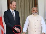 epa05255249 A strong handshake  by Indian prime minister Nanrendra Modi (C) leave a impression at the Britain's Prince William's hand prior to a meeting  at Hyderabad House in New Delhi, India 12 April 2016. Prince William and his wife Catherine are on a visit to India and Bhutan from 10 to 16 April.  EPA/HARISH TYAGI