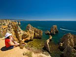 Woman with a view to Ponta da Piedade in Algarve, Portugal, Europe.