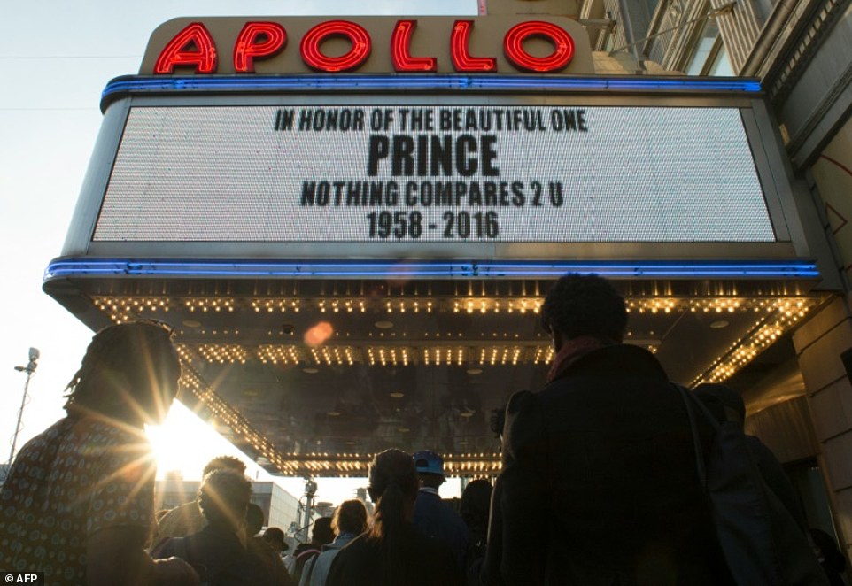 People gather outside the Apollo Theater to listen to music by Prince on Thursday, April 21, 2016 in New York