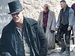 Picture Shows: Tom Hardy  4th May 2016:\n \n British actor Tom Hardy in character filming his new TV show "Taboo" on Tuesday.\n The filming took place in Cornwall, at Charlestown Harbour, looking every inch the Georgian gentleman \n \n Tom was in Georgian clothing wearing a black coat, shirt, waistcoat and wellington hat.\n \n Also on set was co-star Stephen Graham who was covered in blood and had bizarre tattoos on his head.\n \n Worldwide Rights