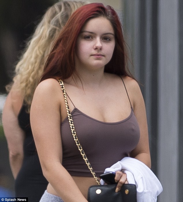 Relaxed outing: Ariel's flame-colored lengthy tresses were styled straight and worn down, and the bare-faced beauty opted for no make-up. Ariel's new manicure was on display as held her cell phone in hand and appeared to be searching for something inside her handbag