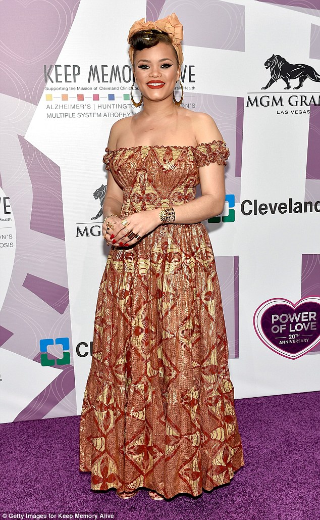 Colorful: Recording artist Andra Day, 31, delighted in a strapless dress featuring an intricate gold and burgundy pattern