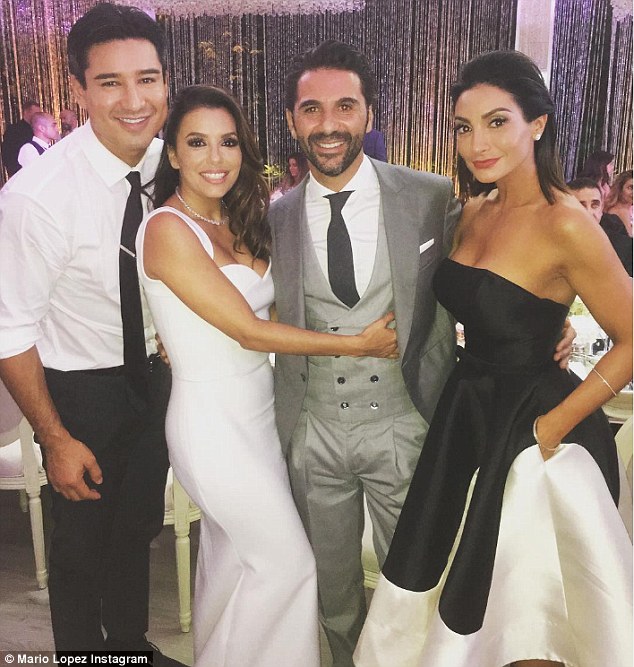 Blushing bride: Eva looked gorgeous in her Victoria Beckham designed dress as she posed with her new husband and Mario Lopez