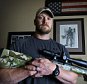 Chris Kyle, a retired Navy SEAL and bestselling author of the book "American Sniper: The Autobiography of the Most Lethal Sniper in U.S. Military History", holds a .308 sniper rifle in this April 6, 2012, file photo. Kyle was one of two people reported killed on the gun range at Rough Creek Lodge near Glen Rose, Texas, Saturday, February 2 2013. (Paul Moseley/Fort Worth Star-Telegram/MCT via Getty Images)