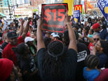 Protesters rally outside a McDonald's in Chicago to demand $15 per hour pay, Wednesday, May 25, 2016 in Chicago.  Demonstrations are also expected Thursday during the shareholders' meeting at McDonald's headquarters in suburban Oak Brook. Low-wage workers are pressing their demand for a higher minimum wage. The push for a $15 minimum wage began in 2012. Since then, the growing demonstrations have helped make hourly pay a political issue. (Antonio Perez/Chicago Tribune via AP) MANDATORY CREDIT CHICAGO TRIBUNE; CHICAGO SUN-TIMES OUT; DAILY HERALD OUT; NORTHWEST HERALD OUT; THE HERALD-NEWS OUT; DAILY CHRONICLE OUT; THE TIMES OF NORTHWEST INDIANA OUT; TV OUT; MAGS OUT; NO SALES