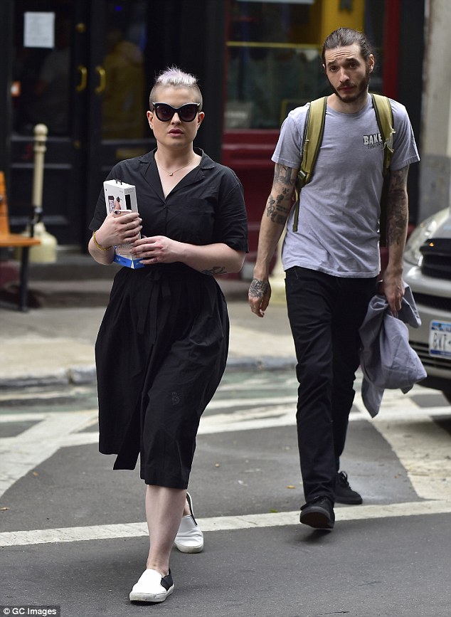 Best pals: The lilac haired talk show host sported a flowing black short sleeved dress and a pair of cat eye sunglasses as she wandered the streets of the Big Apple with a male friend
