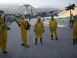 Health workers pictured in January spraying insecticide to combat the Aedes aegypti mosquitoes that transmits the Zika virus, at the Sambadrome in Rio (AP)