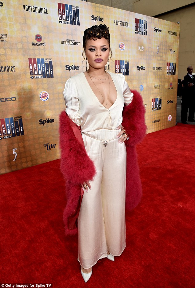 More than chest a glimpse! Andra Day took the plunge in a silky baby pink jumpsuit which put her ample cleavage on full show
